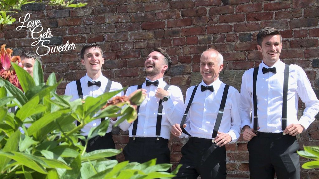 the boys laughing in their braces and bow ties for the wedding photographer